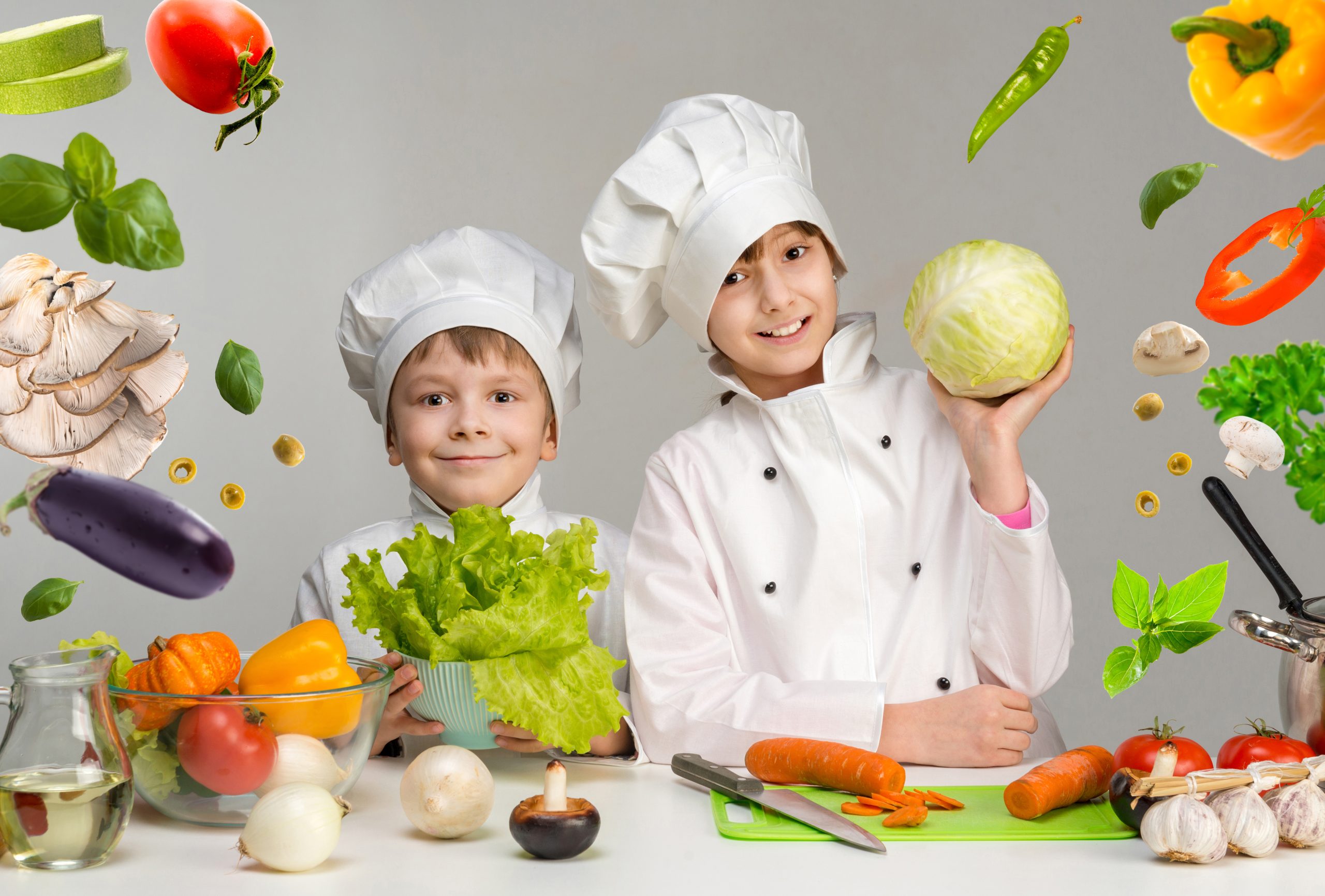 two-smiling-children-cooks-by-the-table-with-flyin-2025-04-01-13-13-20-utc